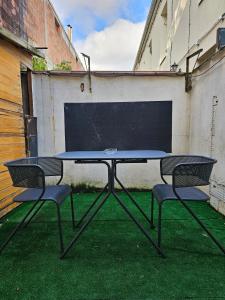 - une table de ping-pong avec 2 chaises sur l'herbe dans l'établissement Petite maison proche du métro, à Bagnolet