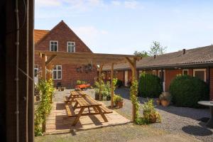 a picnic table in the courtyard of a house at Holiday Apartment At Beautiful Solgaarden 8 in Svaneke