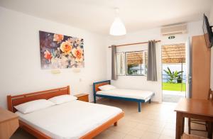 A bed or beds in a room at Rosa's Beach Studios