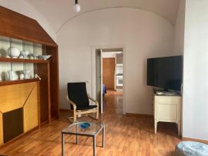 a living room with a chair and a flat screen tv at D116 Home - Your Perfect Place in Naples