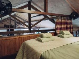 a bedroom with a bed with two pillows on it at Casa dos Botes in Santa Cruz das Flores