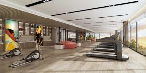 a gym with treadmills and ellipticals in a room at Argyle Grand Hotel Nairobi Airport in Nairobi