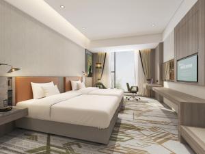 a hotel room with two beds and a desk at Argyle Grand Hotel Nairobi Airport in Nairobi