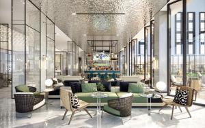 a lobby with a couch and tables and chairs at Argyle Grand Hotel Nairobi Airport in Nairobi