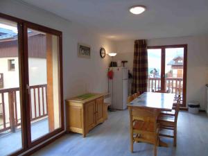 a kitchen with a table and a refrigerator at Appartement Valfréjus, 3 pièces, 6 personnes - FR-1-561-23 in Valfréjus