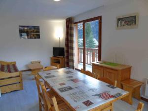 a dining room with a table and chairs and a window at Appartement Valfréjus, 3 pièces, 6 personnes - FR-1-561-23 in Valfréjus