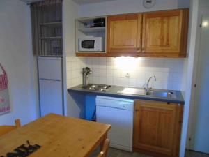 a small kitchen with a sink and a microwave at Appartement Valfréjus, 2 pièces, 6 personnes - FR-1-561-80 in Valfréjus