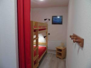 a small room with a bunk bed and a red curtain at Appartement Valfréjus, 2 pièces, 6 personnes - FR-1-561-80 in Valfréjus