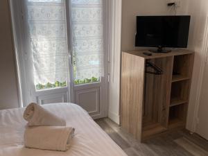 a bedroom with a bed with a television and windows at Studio Aix-les-Bains, 1 pièce, 2 personnes - FR-1-617-25 in Aix-les-Bains