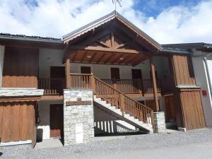 a house with a large deck and a staircase at Appartement Valfréjus, 3 pièces, 8 personnes - FR-1-561-59 in Valfréjus