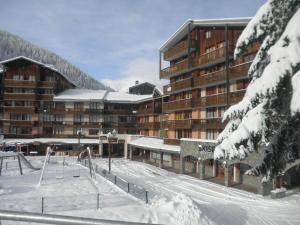 a large building with a playground in the snow at Studio Valfréjus, 1 pièce, 3 personnes - FR-1-561-106 in Modane