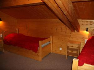 une chambre avec deux lits dans une cabane en rondins dans l'établissement Chalet à Montalbert: 3 Chambres, Mezzanine, Cheminée, Cuisine Équipée, Parking - FR-1-755-7, à Aime La Plagne