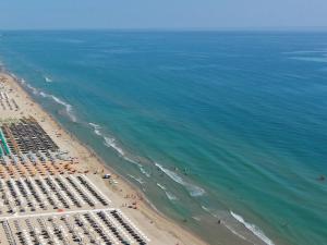 an aerial view of a beach with chairs and the ocean at Hotel Corallo in Giulianova