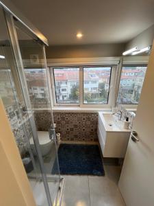 a bathroom with a shower and a toilet and a sink at GROW- Casa Parque da Cidade in Porto