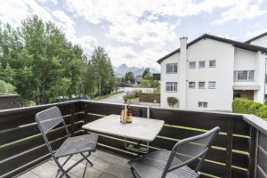 a patio with a table and chairs on a balcony at Chasa Trü Nr. 8 in Scuol
