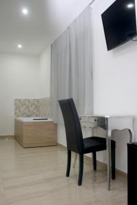 Телевизор и/или развлекательный центр в B&B Villa Anna