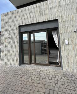 a building with a large sliding glass door at Blouberg by the Sea in Cape Town