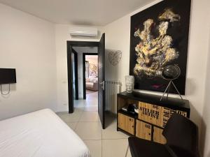 - une chambre avec un lit et une peinture murale dans l'établissement Appartamento con giardino a 5 min dal Mare - Burlamacco House, à Viareggio