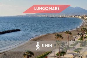 a poster of a beach with a person walking on the beach at Pangea Rooms in Castellammare di Stabia