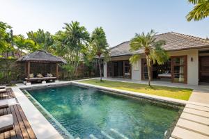 an image of a swimming pool in front of a house at Villa 500m2 with 14m Pool, BBQ, Pinball - Seminyak in Seminyak