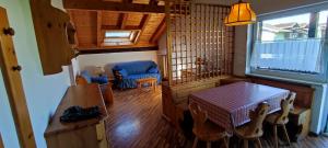 a living room with a table and a dining room at CASA CAVALESE in Cavalese