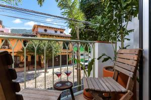 a balcony with a bench and a view of a courtyard at Casa Lucas in Puerto Vallarta