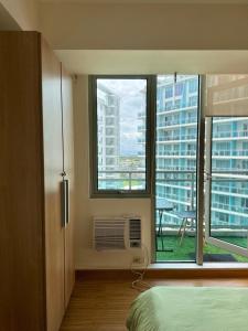 a room with a bed and a window with a view at Azure Staycation Near the Airport in Manila
