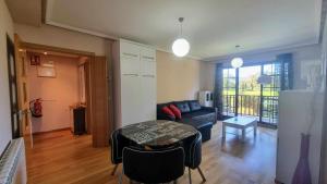 a living room with a couch and a table at Apartamento La Ventana del Cuera in Llanes