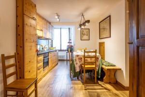 a kitchen with a table and a dining room at LUVI - Courmayeur in Courmayeur