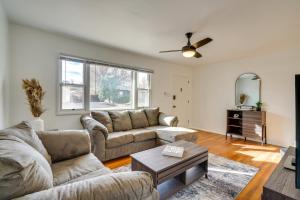 a living room with two couches and a table at Chic Pueblo Vacation Rental Home Near Fairgrounds! in Pueblo