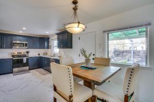 a kitchen with a wooden table and chairs at Chic Pueblo Vacation Rental Home Near Fairgrounds! in Pueblo