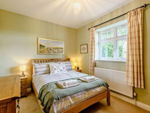 a bedroom with a bed and a window at 2 bed property in Wareham 83814 in Morden
