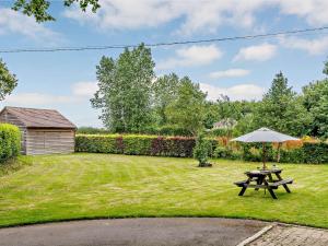 un tavolo da picnic con ombrellone in un cortile di 2 bed property in Wareham 83814 a Morden