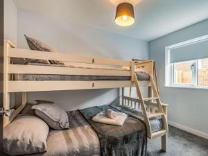 a bedroom with two bunk beds and a window at 2 Bed in Caister-on-Sea 87689 in Caister-on-Sea