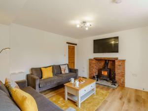 a living room with a couch and a fireplace at 2 bed property in Keswick 86249 in Rosthwaite