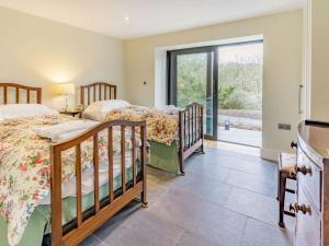 a bedroom with two beds and a sliding glass door at 2 bed property in Cowbridge 87576 
