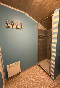 a bathroom with a shower stall and a shower door at Le Domaine de Laurolie in Gaujacq