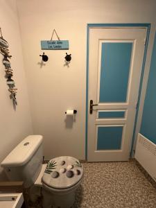 a bathroom with a toilet and a door at Le Domaine de Laurolie in Gaujacq