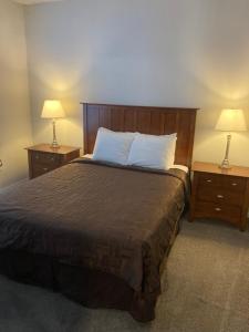 a bedroom with a large bed with two night stands at Home Street at Bracken House in Pittsburgh