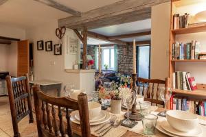 a dining room with a table with chairs and a book shelf at Lovely 2 BD with stunning views over Stroud valley 