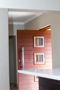 a wooden door with two pictures on the wall at Waterford Executive Apartments in Mbabane