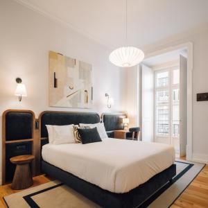 - une chambre avec un grand lit et une tête de lit noire dans l'établissement Ando Living - Madalena Townhouse, à Lisbonne