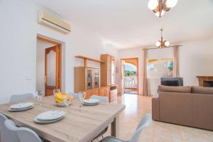 a living room with a table and a couch at Villa Zelda - PlusHolidays in Calpe
