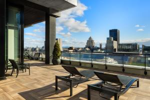 a balcony with chairs and a view of the city at AC Hotel by Marriott Montreal Downtown in Montréal
