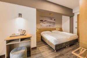 Postel nebo postele na pokoji v ubytování Suàn Hotel