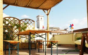 a balcony with a table and a building with a clock tower at B&b Sà Di.. in Monterotondo