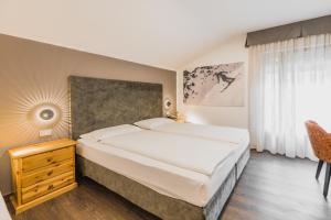 Postel nebo postele na pokoji v ubytování Suàn Hotel