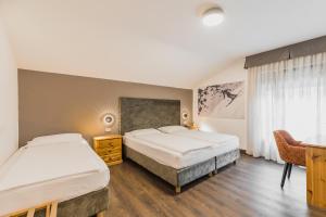 Postel nebo postele na pokoji v ubytování Suàn Hotel