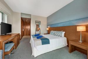 a bedroom with a large bed and a flat screen tv at Hotel Do Caracol in Angra do Heroísmo +37 photos