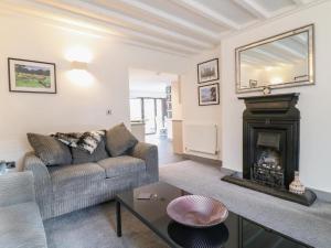 a living room with a couch and a fireplace at Beautiful Holiday Home Village Sleeps up to 6 in West Hallam